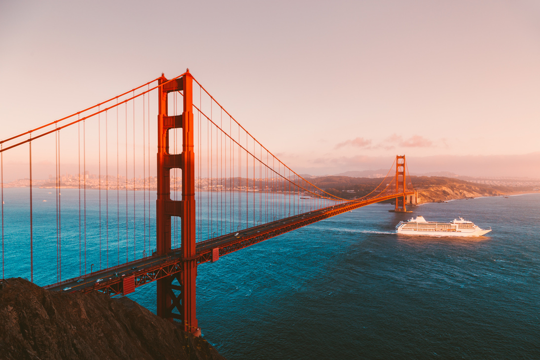 Golden Gate Bridge with cruise ship at sunset, San Francisco, California, USA
